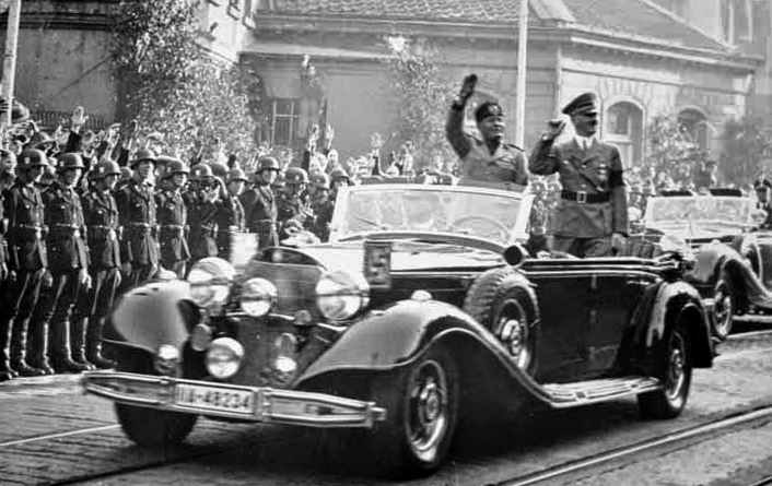 Adolf Hitler and Benito Mussolini drive through Essen